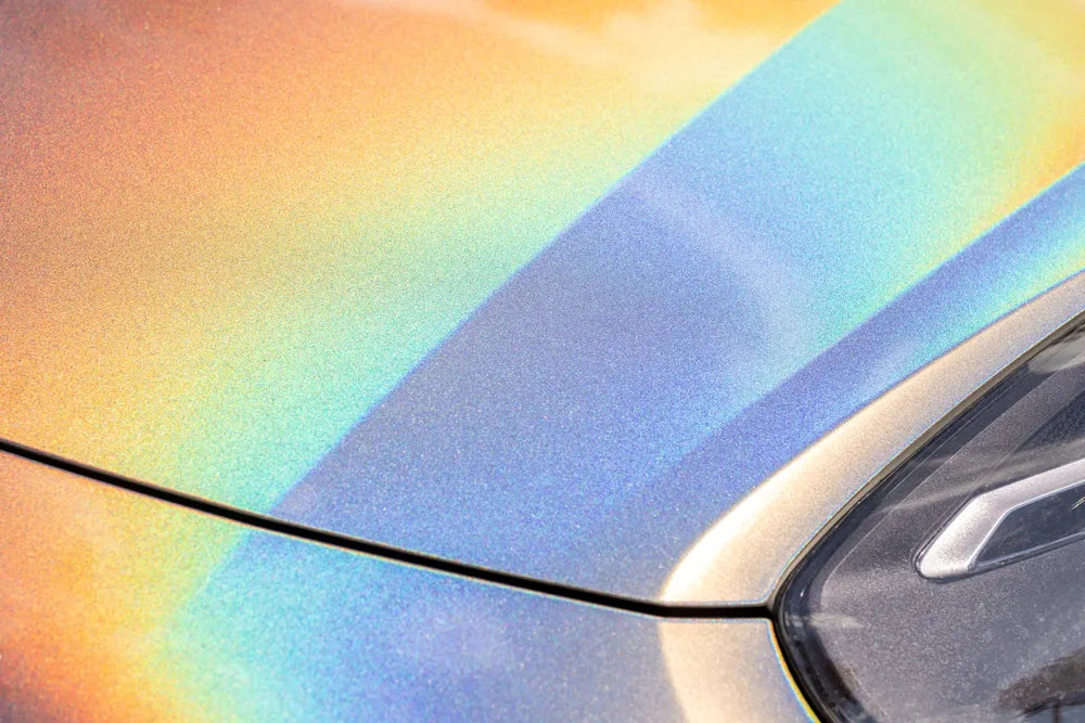 Closeup of a car led headlight and color shifting car paint