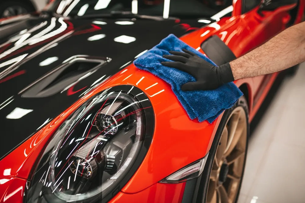 A man cleaning car with cloth, car detailing concept. 